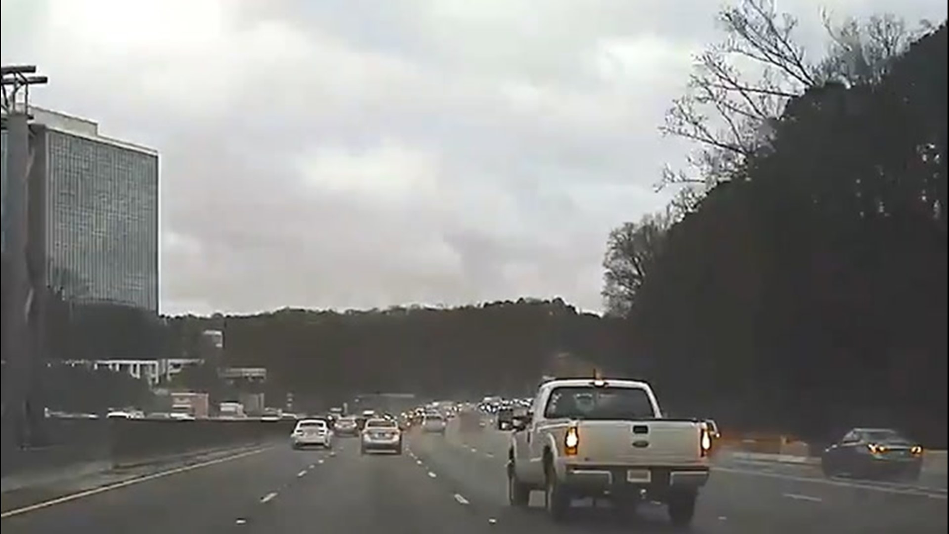 Strong storms knocked a tree onto a car traveling on a highway in Dunwoody, Georgia, on Feb. 6. The driver of the car was able to escape with no serious injuries.