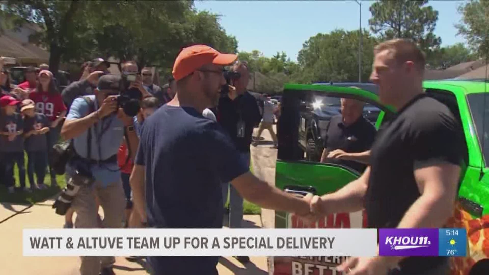 J.J. Watt and Jose Altuve, two of Houston's sports heroes, drove down the block in a bright green Papa John's truck that would be given to one lucky winner in Pearland.