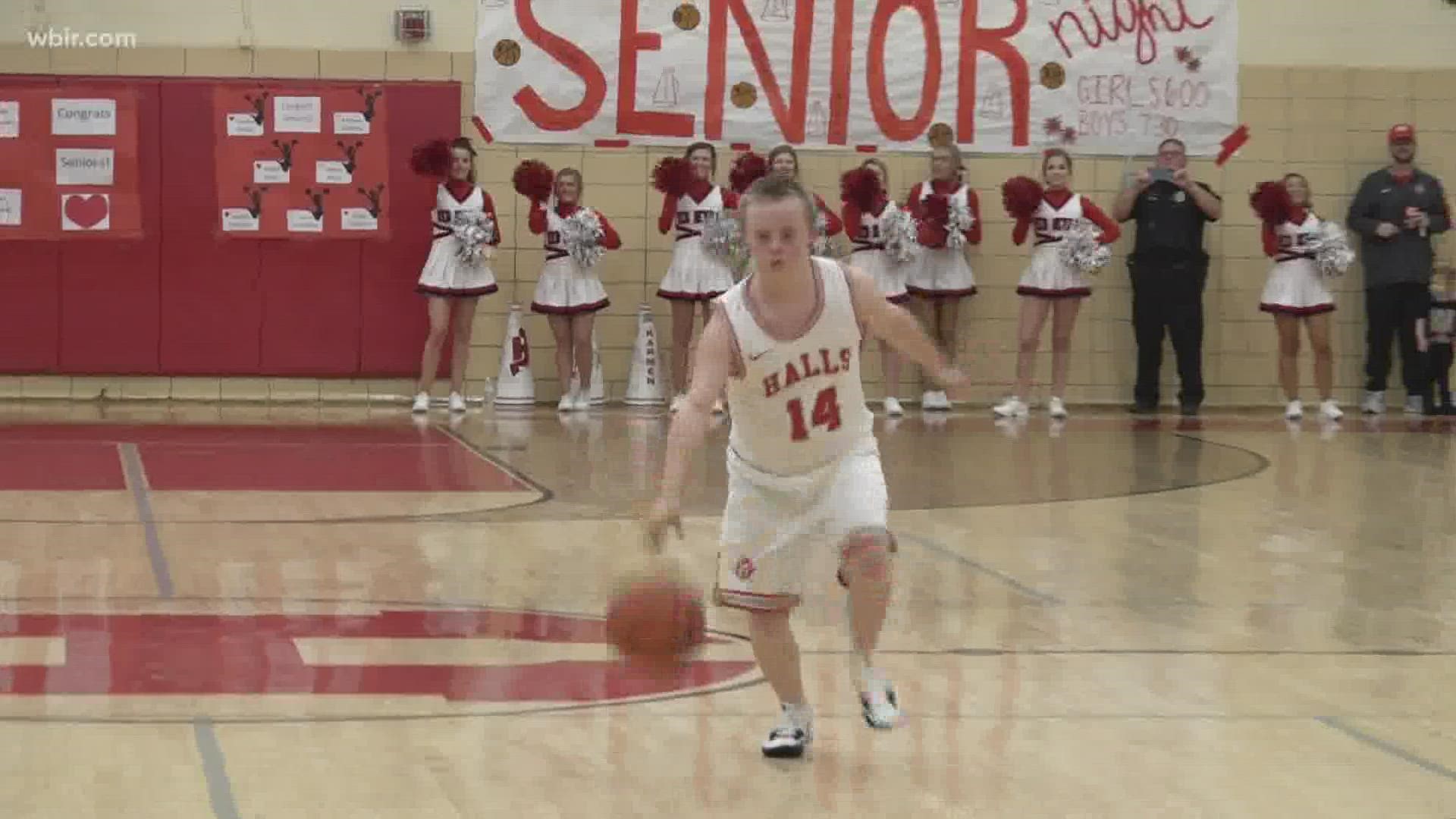 Halls boys' basketball manager, Maddox Shields, scores the Red Devils' first basket on senior night.