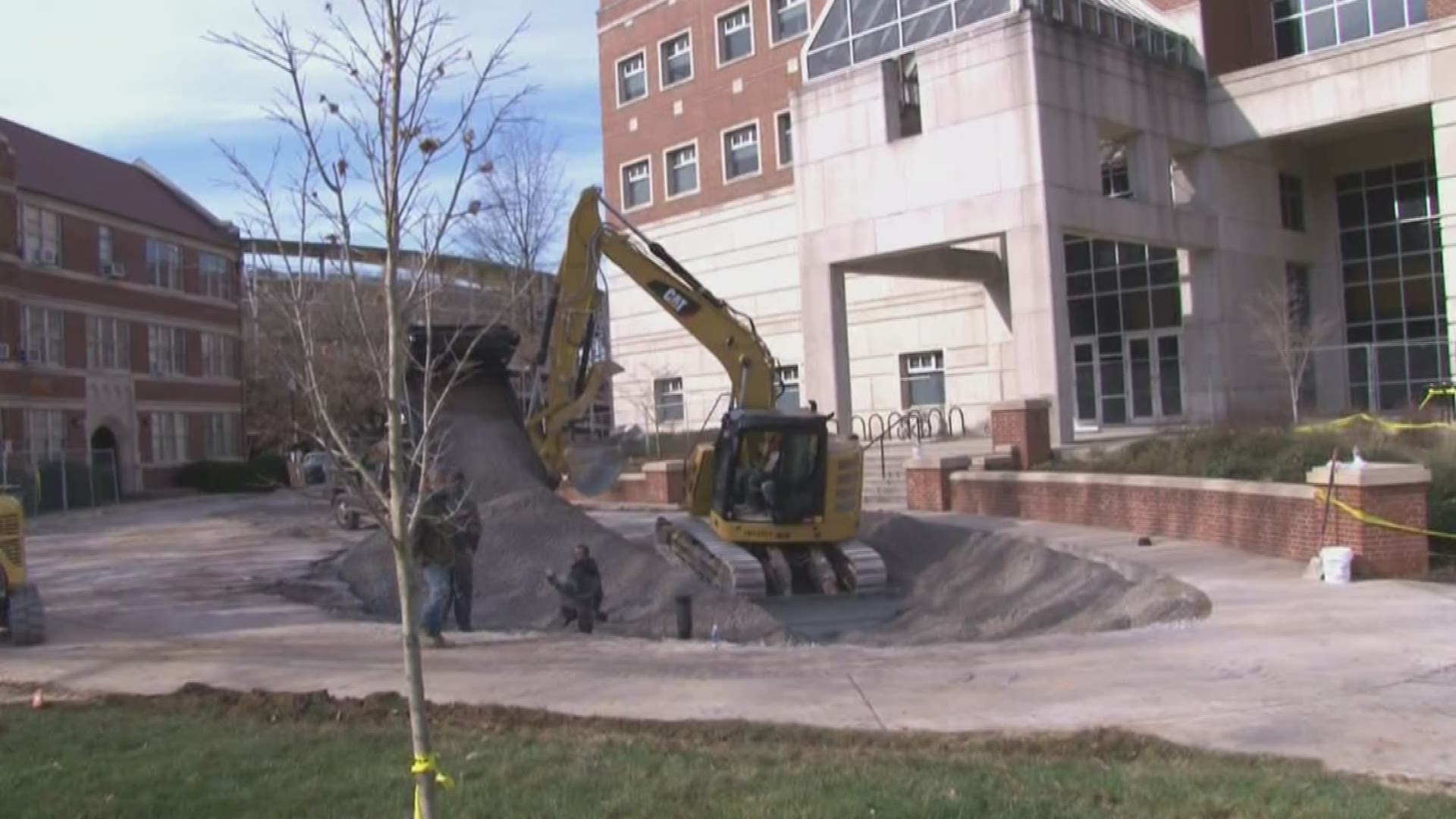 UT said the sinkhole formed after a water main break. Crews are temporarily patching it until they can make permanent repairs over the summer.