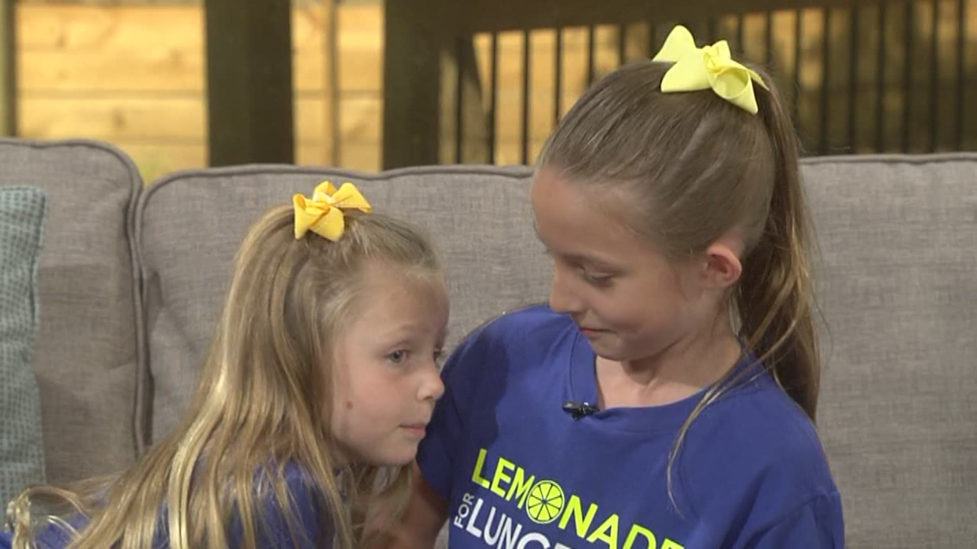 A moment of sisters fussing about their lemonade stand to raise money for lung cancer research