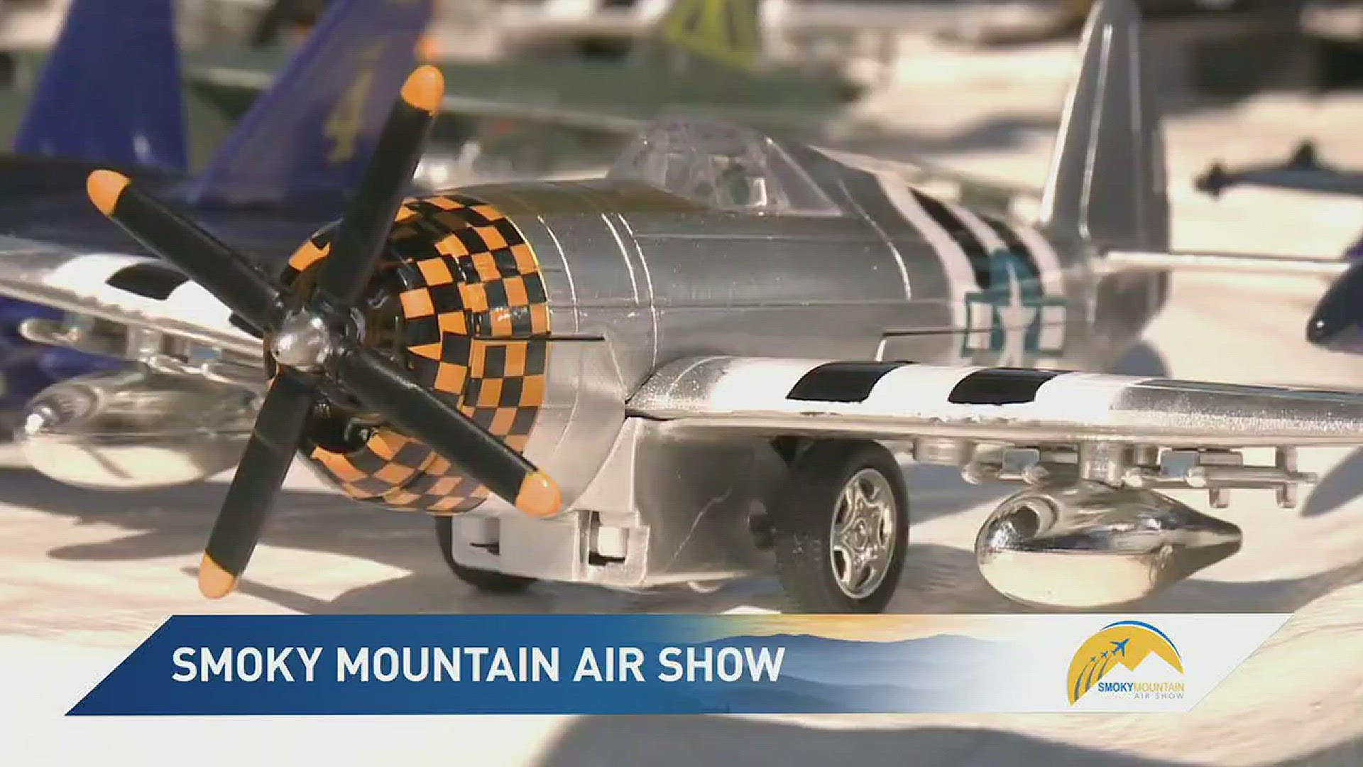 10News reporter Jim Matheny shows the history behind some of the toys sold at the Smoky Mountain Air Show.