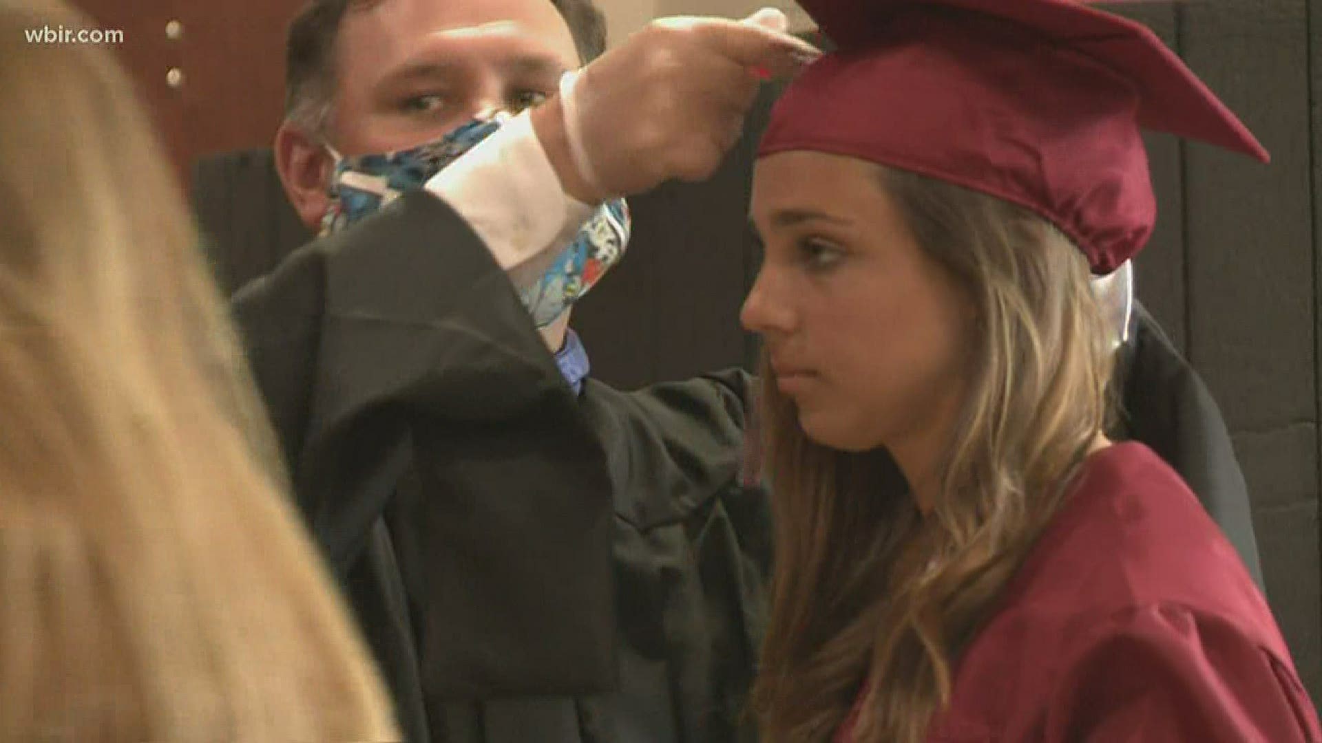 Instead of on a crowded football field, the school moved the graduation ceremony inside and limited it to one student and one family at at time.