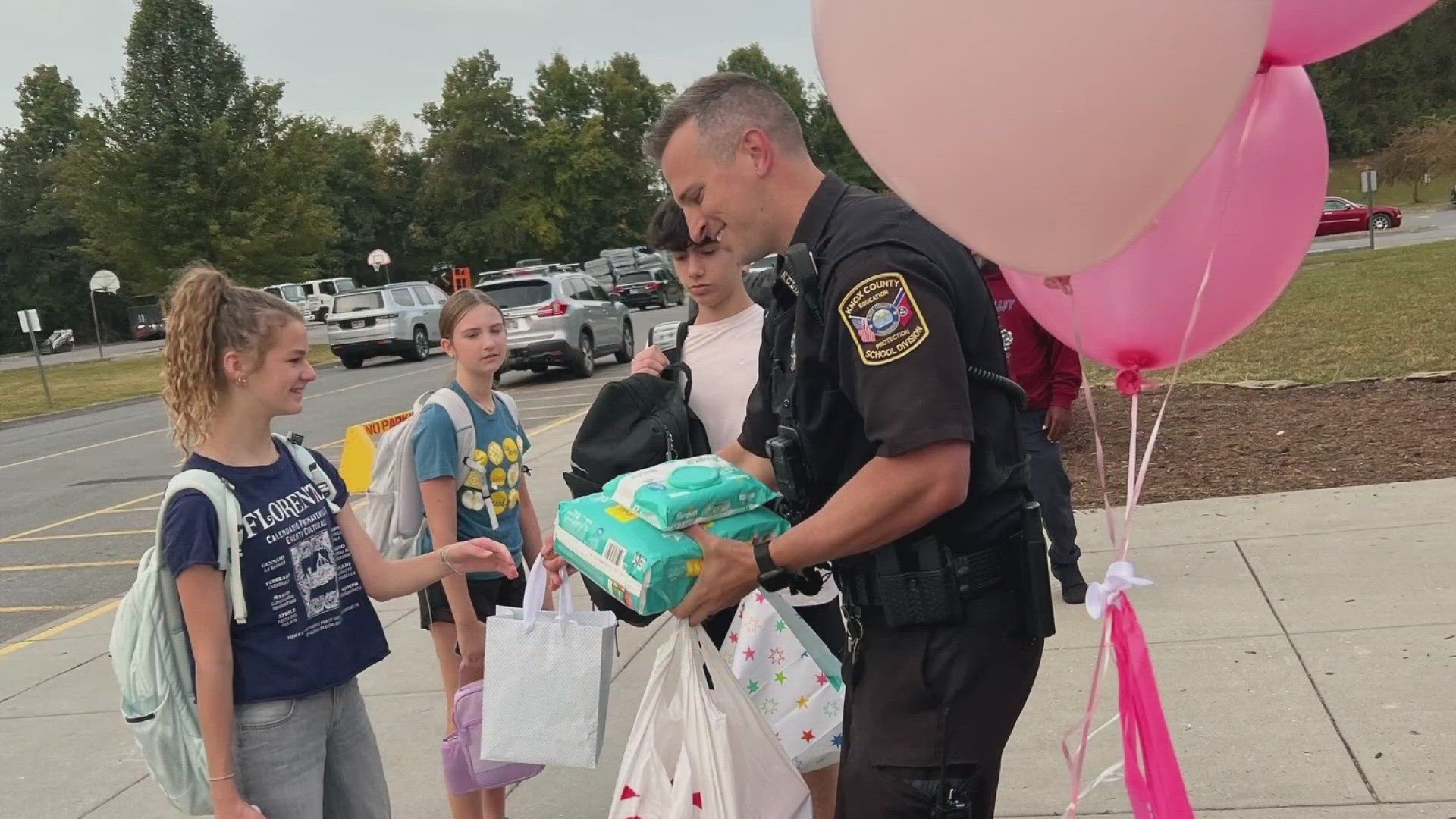 During drop-off Thursday morning, many students got out of their cars and surprised the expecting father with diapers, wipes and gift cards.