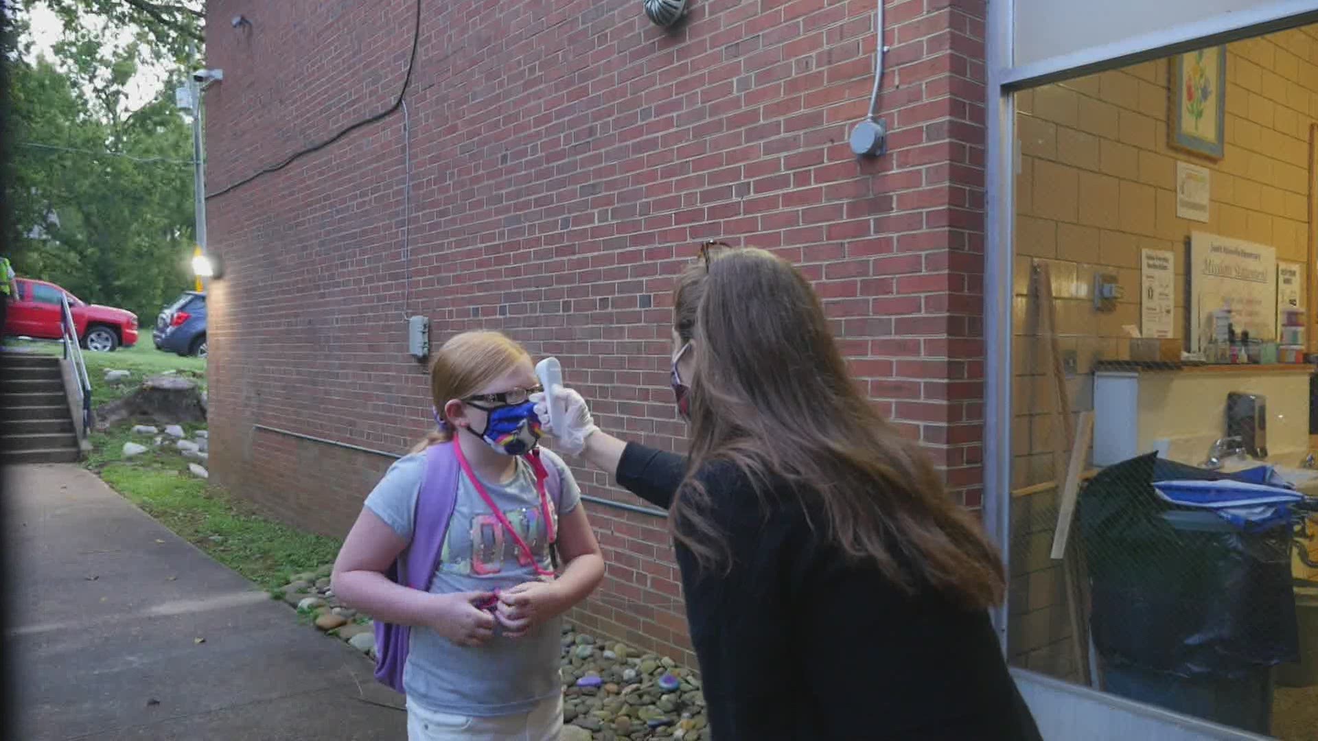 Day one of classes at South Knoxville Elementary School included masks, one-way stairways and air high-fives at the front door.