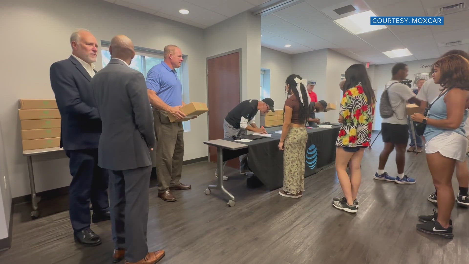 Volunteers chose the families who would get the computers and handed them out on Monday.