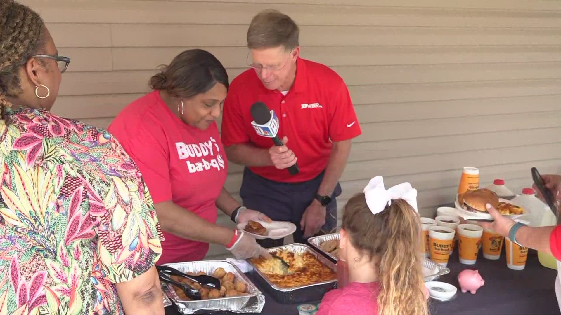 Todd Howell, with Buddy's BBQ, is getting food ready for the people in Clinton.