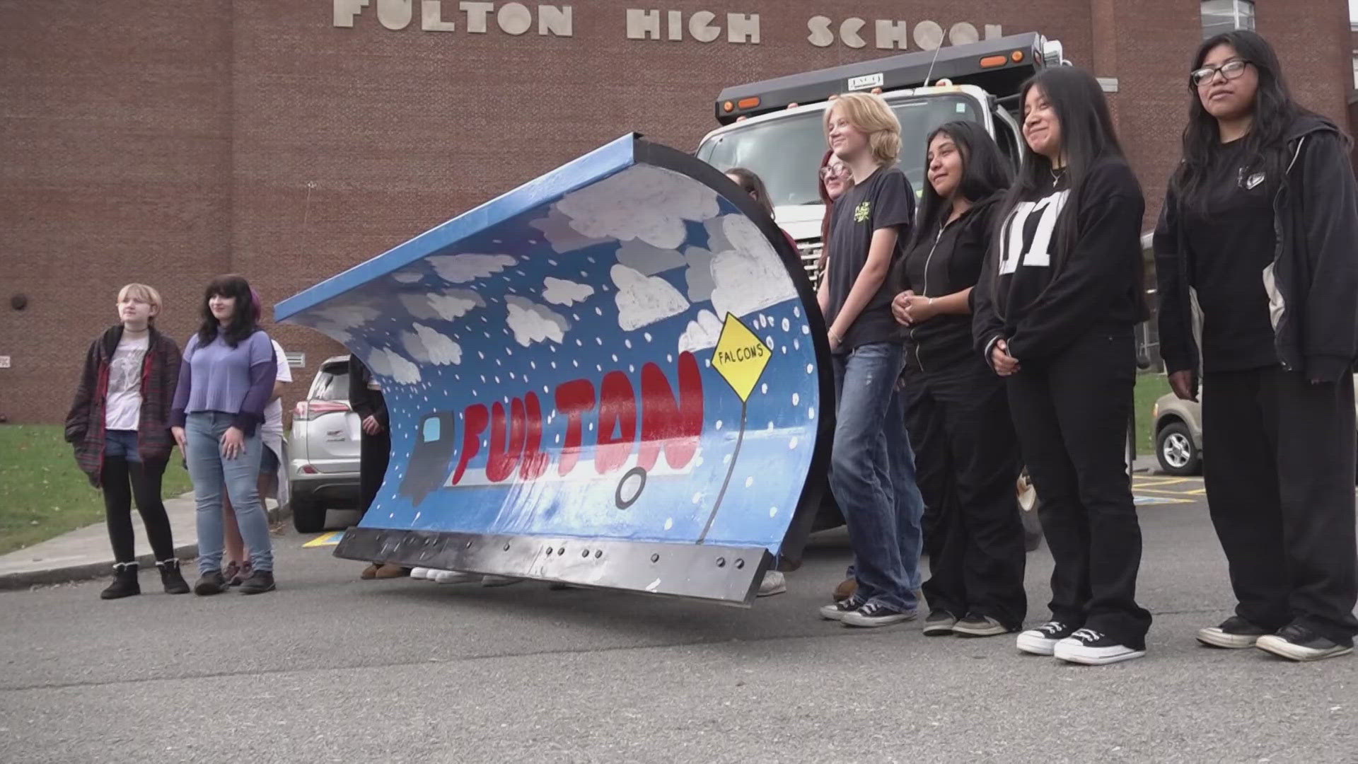 The art students painted a plow that they hope will get people to slow down during the wintery weather season. 