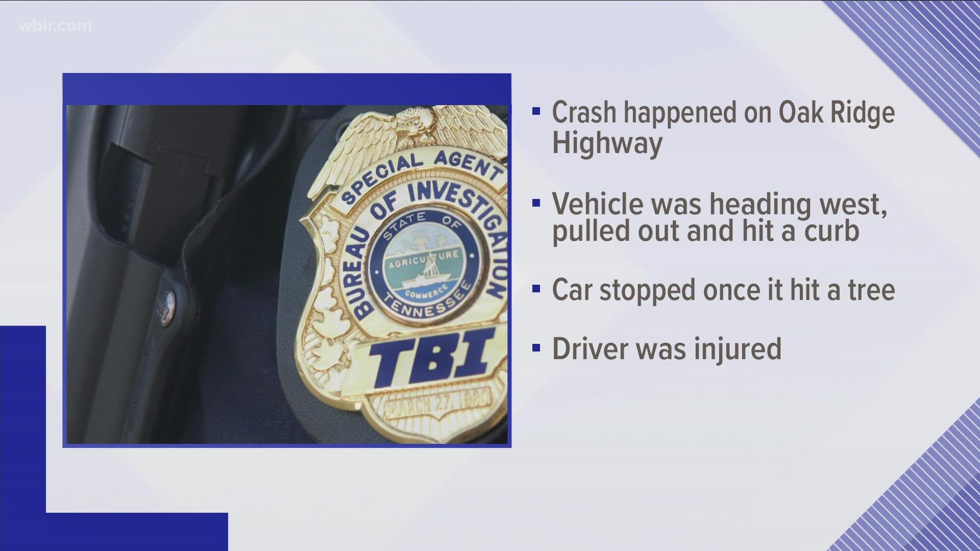 Officials said a person was injured after a car hit a cement curb near an intersection and drove off the right shoulder, hitting a tree.