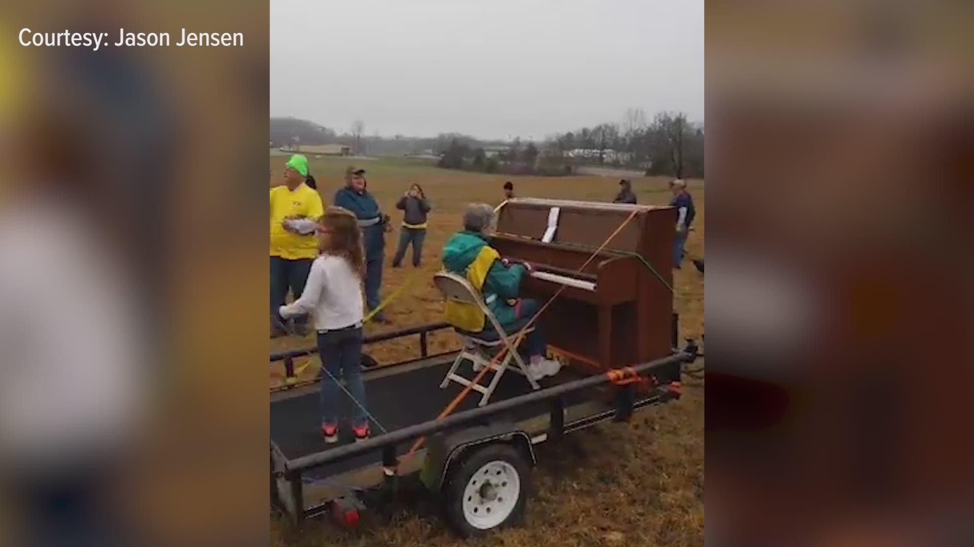 Jane Turvaville perched on a trailer in the middle of a field to play her piano and encourage the volunteers.