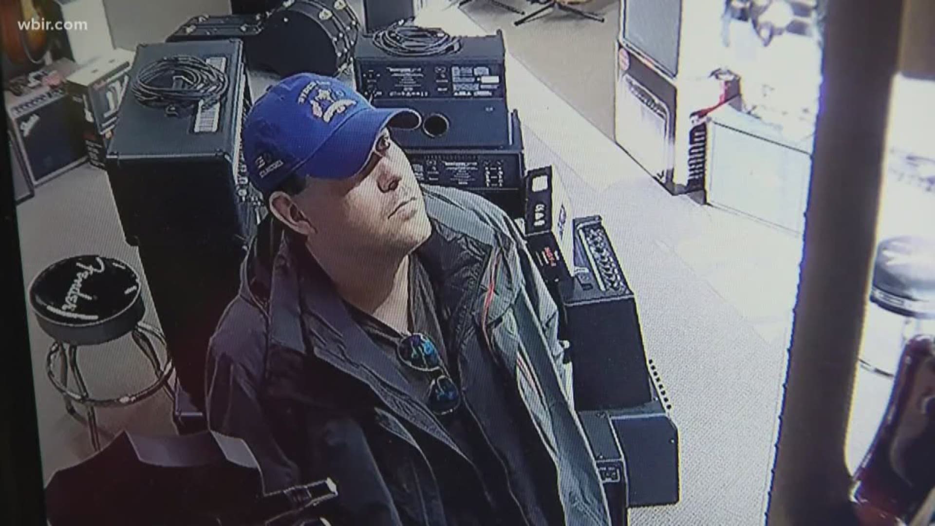 Store owners say security cameras catch a man stealing guitars by putting them in his pants.