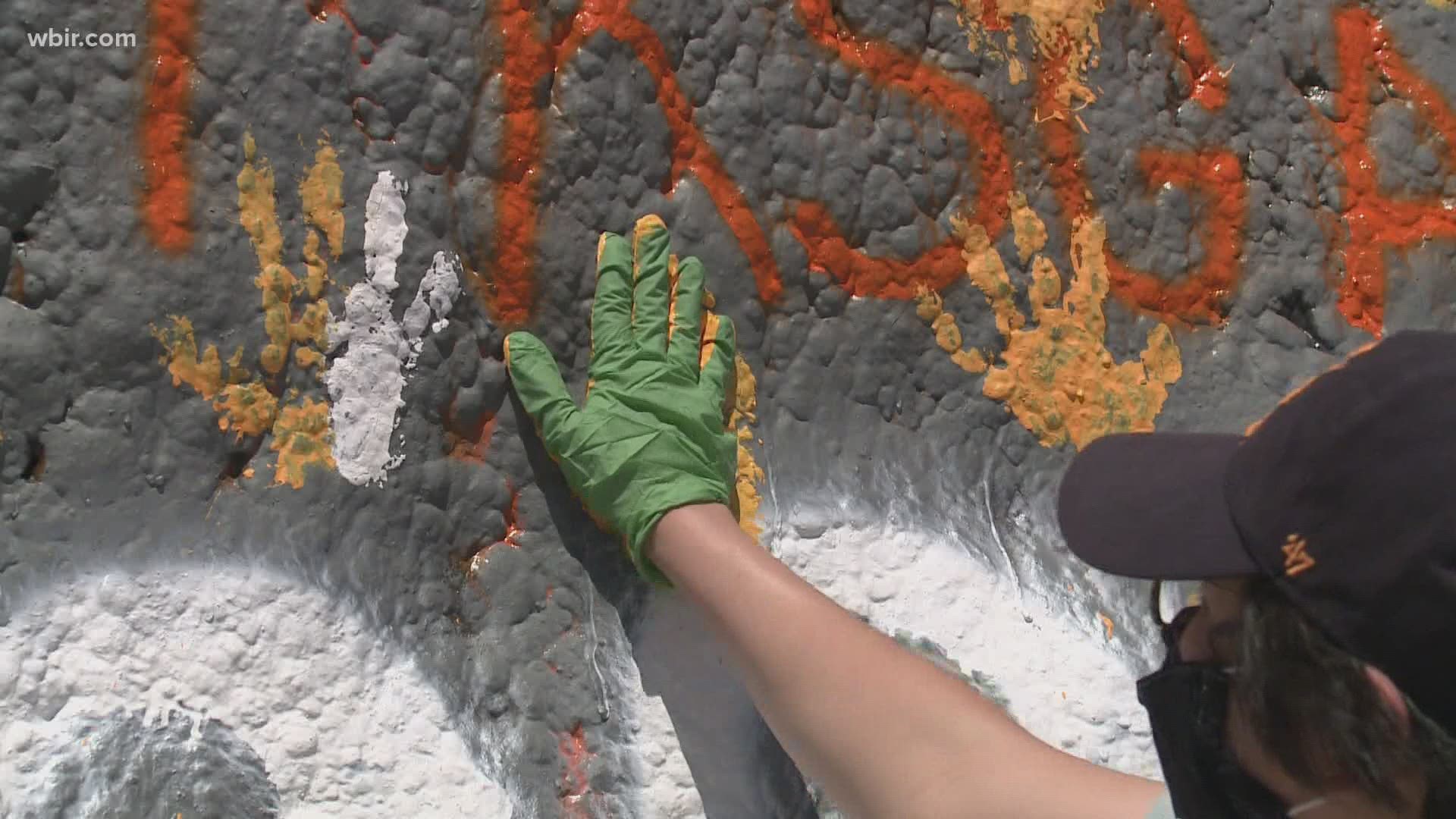 The tradition looked a little different this year, as students wore masks and gloves to leave their mark on The Rock.