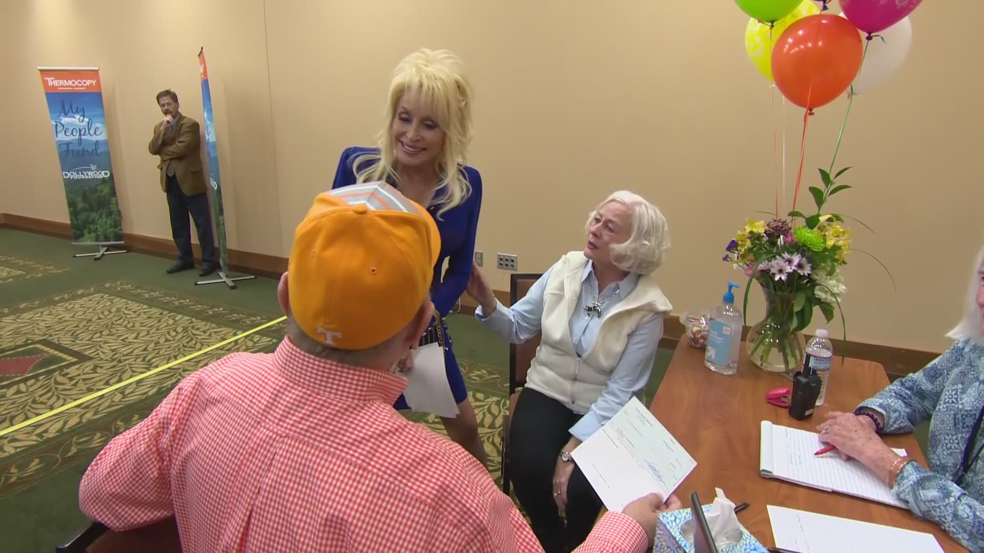 Dolly handed over a $5000 check to each wildfire survivor, instead of the $1000 they were expecting. Video courtesy: Dollywood Foundation