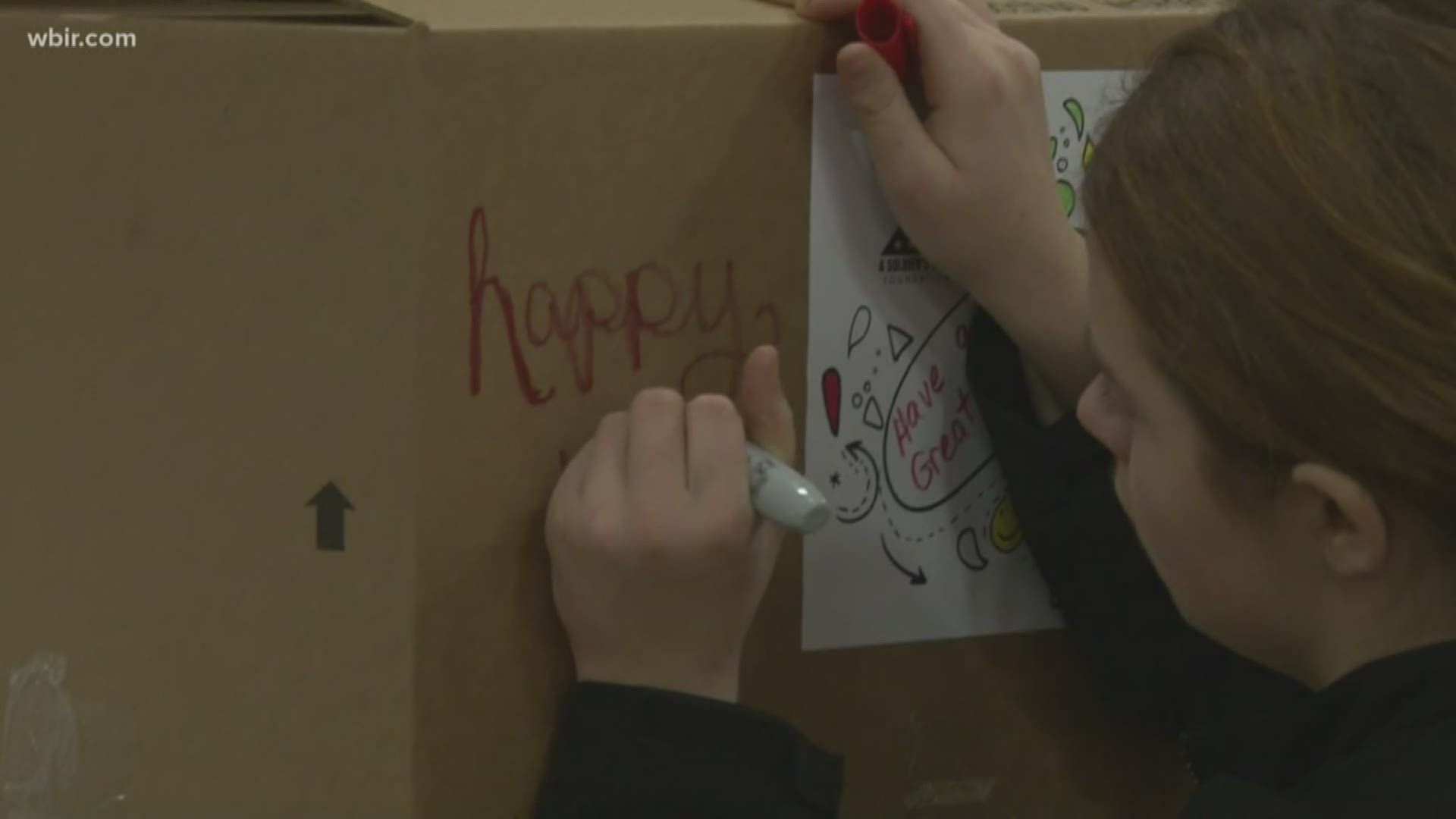 Volunteers and uniformed service members wrapped presents for children who lost parents in active duty. Then, they threw a party for East Tennessee children.