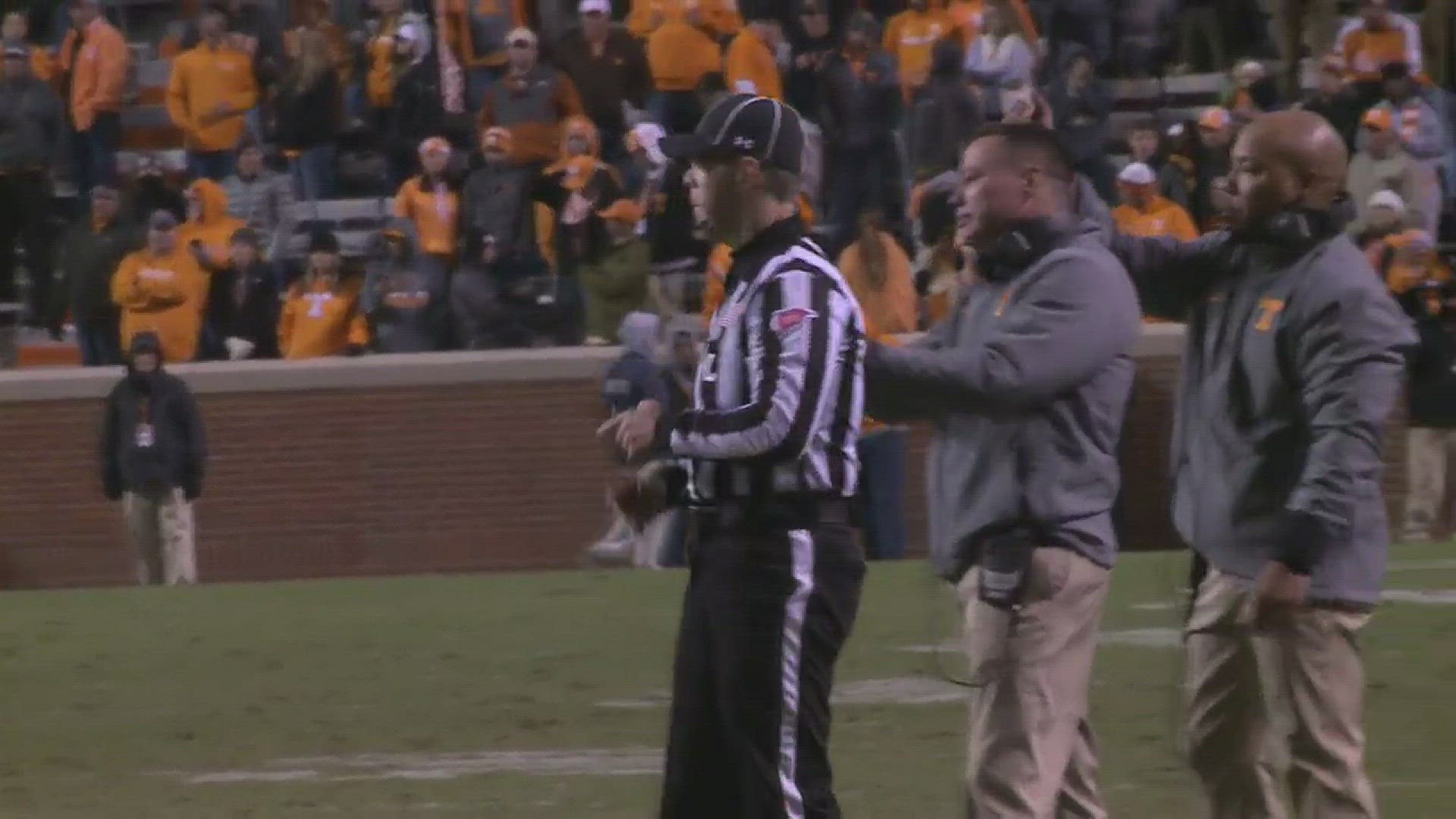 Josh Dobbs embraces Butch Jones, and conducts the band during "Rocky Top" in his Neyland finale.