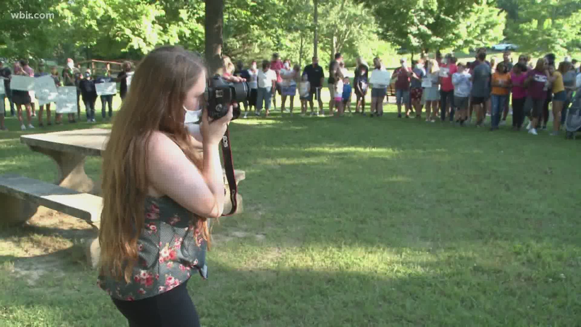 Two photographers brought dozens of people together with a photo shoot to show support among all races.