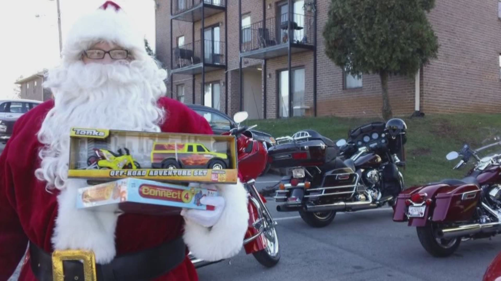 The HOG riders roll up to children's houses with Santa on a motorcycle pulled sleigh to deliver Christmas cheer.