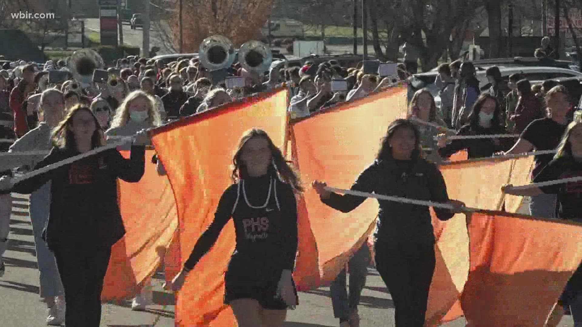 The school celebrated its first state title. The marching band led the team around the school with classmates watching on.