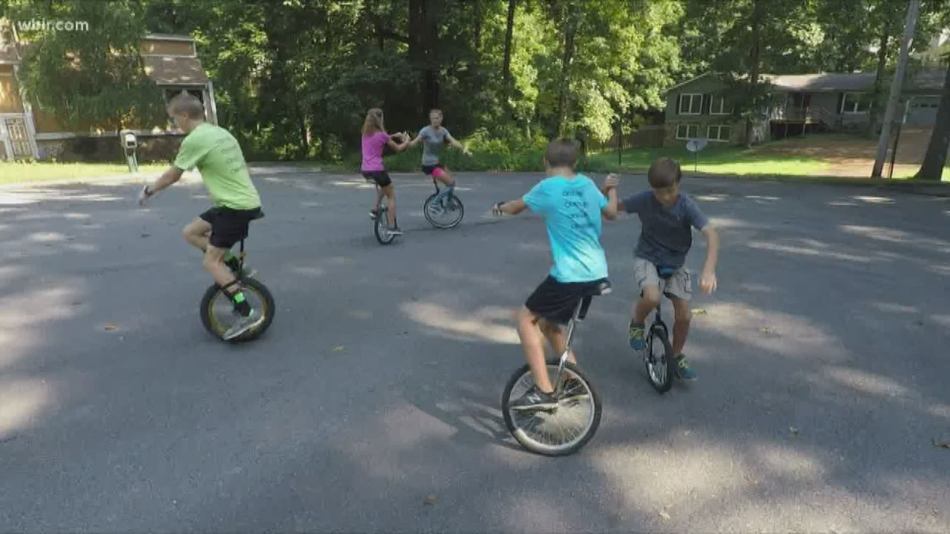 Their matching t-shirts embrace the motto of the unicycling family: one way, one truth, one life, one wheel