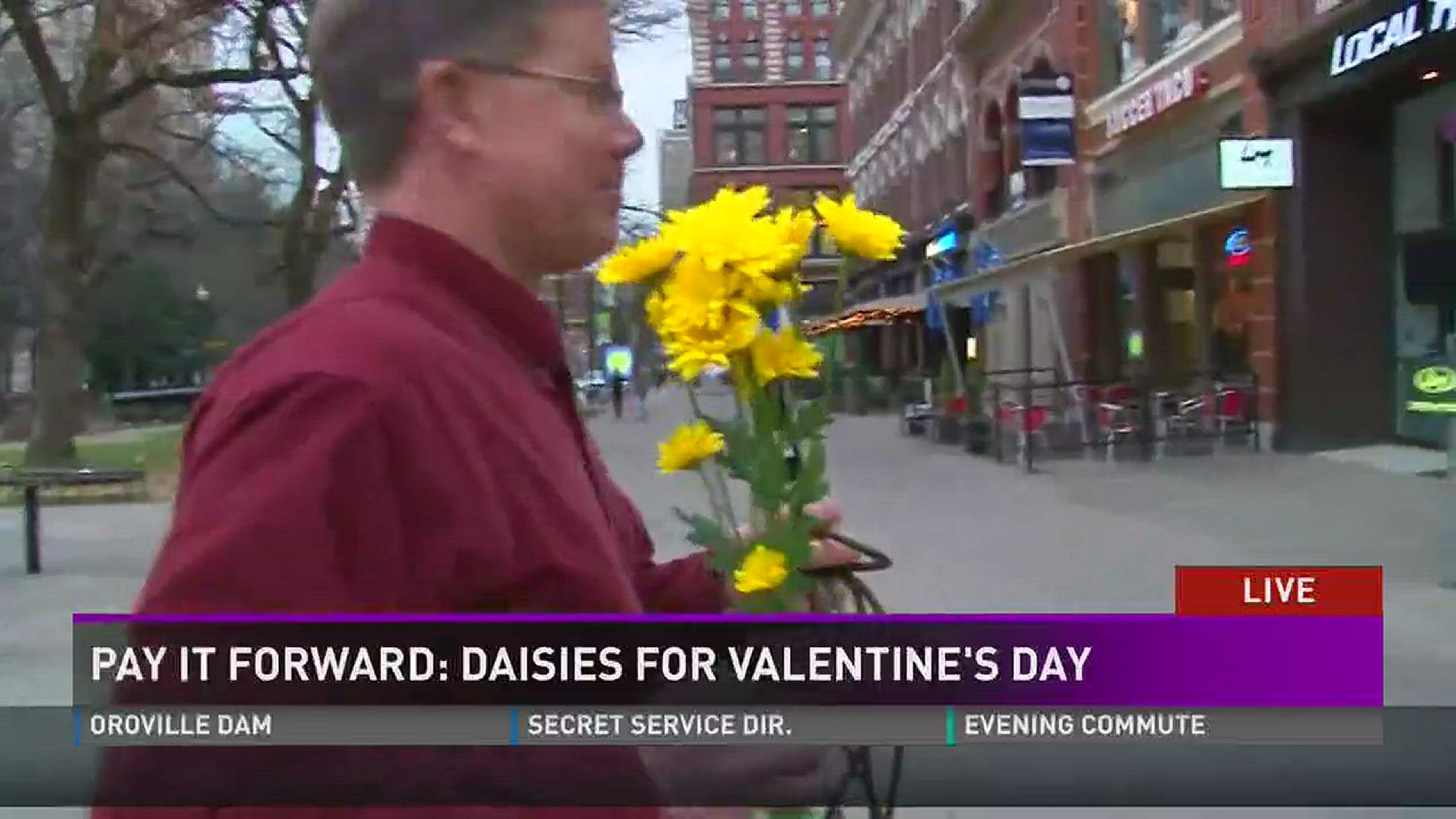 Meterologist Todd Howell is handing out daisies in Market Square.