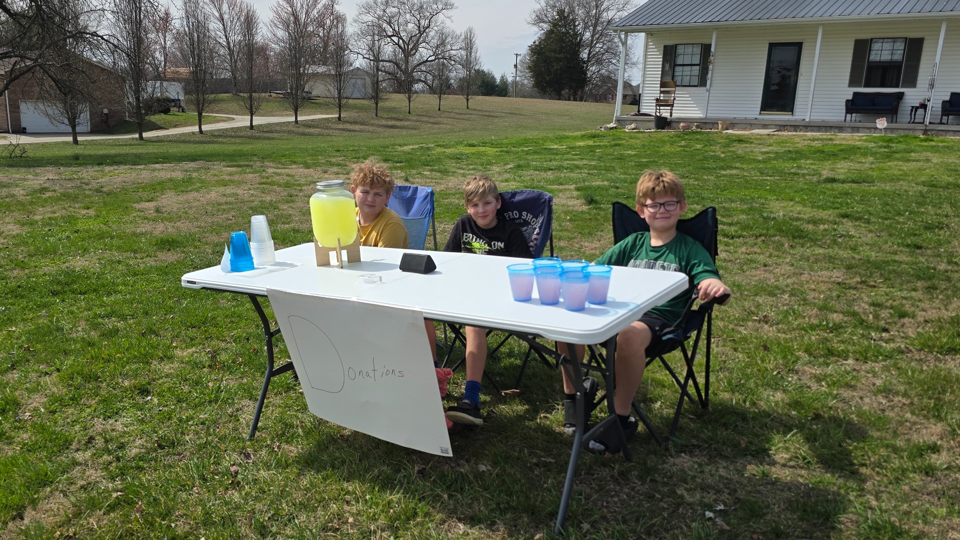 3 boys set up lemonade stand across from Sunnyview Elementary School, a