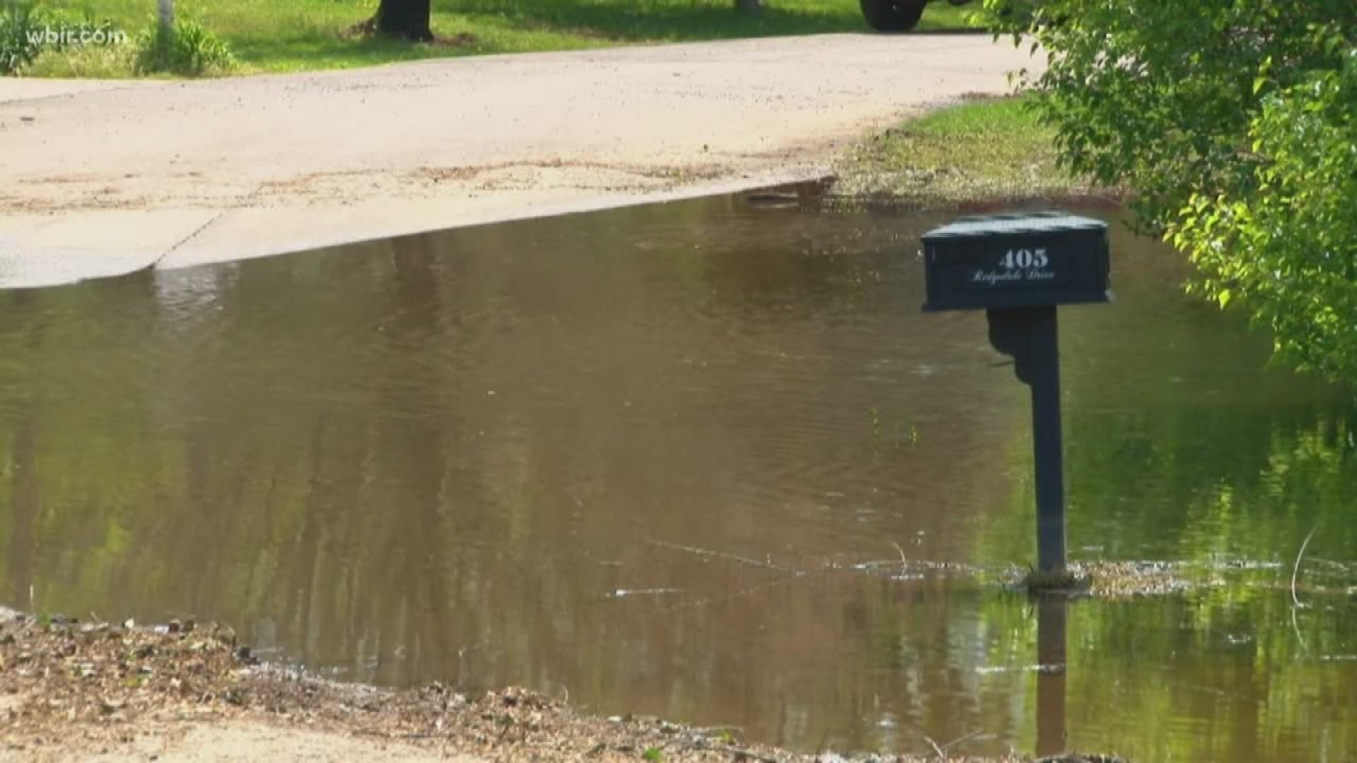 Jefferson County commissioners are paying to help pump water out of a neighborhood still flooded by February's heavy rain showers.