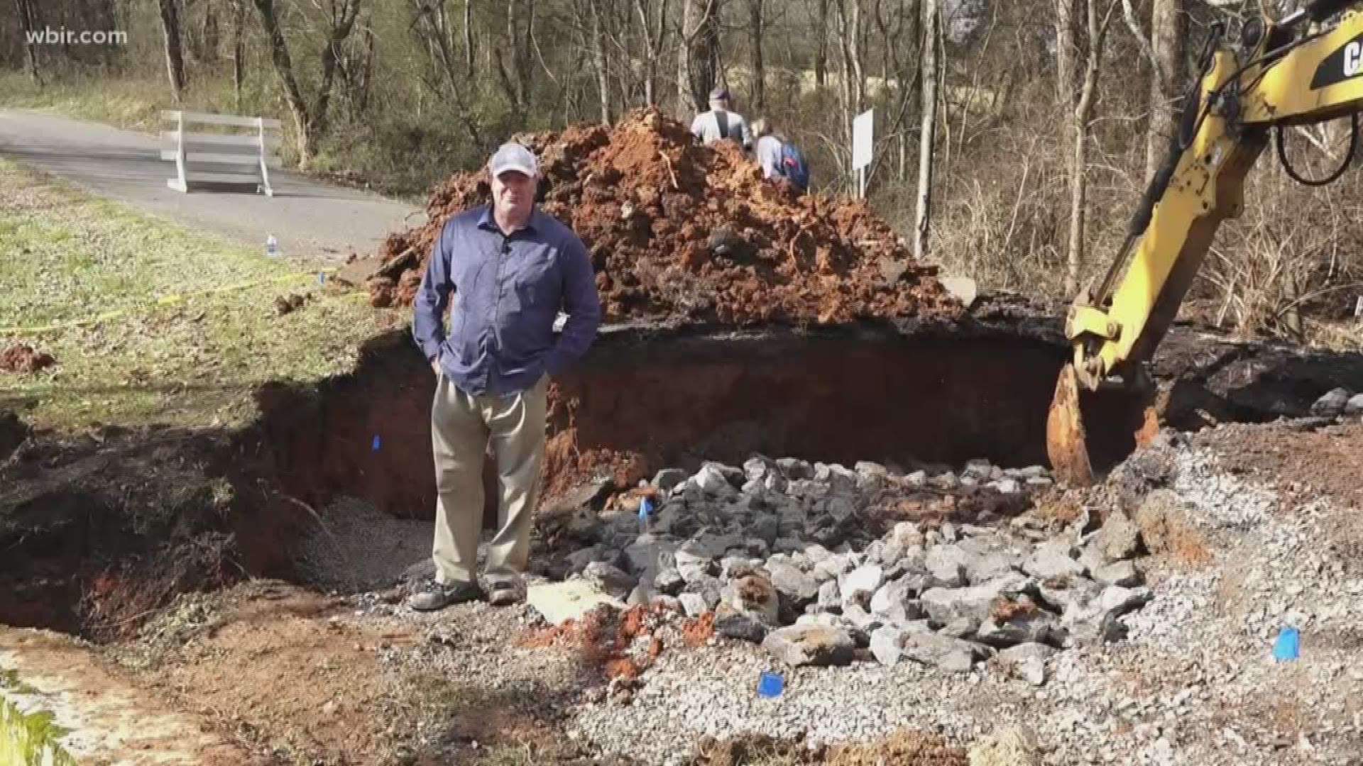 About 25 families were cut off when heavy rains caused a sinkhole on the road leading to their homes.