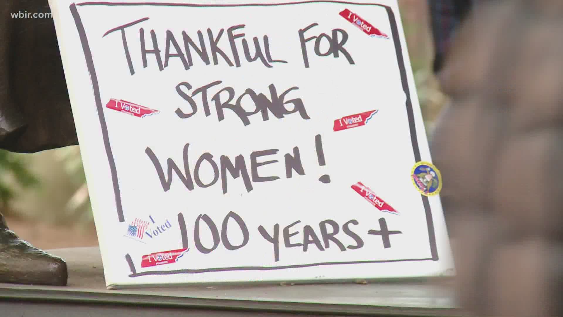 The women's suffrage memorial in downtown Knoxville was decorated with flowers and signs after Kamala Harris was elected as the first woman Vice President.