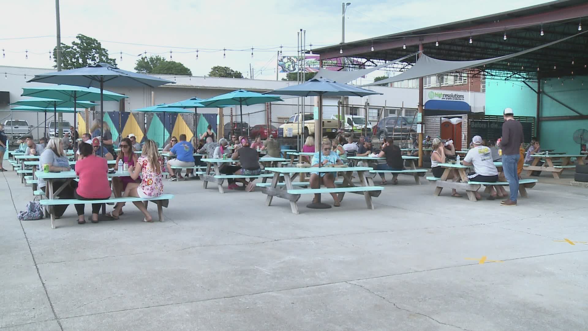 The Knoxville food truck park hosted six trucks. 
Tables were separated for social distancing and employees were cleaning as people came and went.