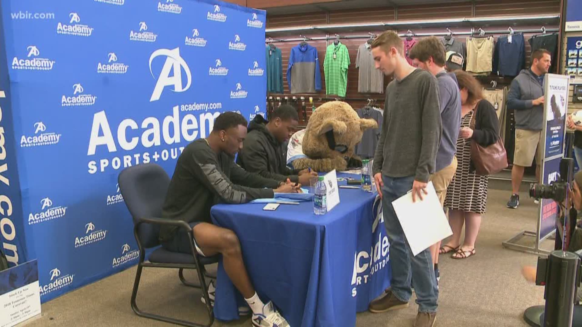 Corey Davis and Jayon Brown sign autographs at Academy Sports & Outdoors.