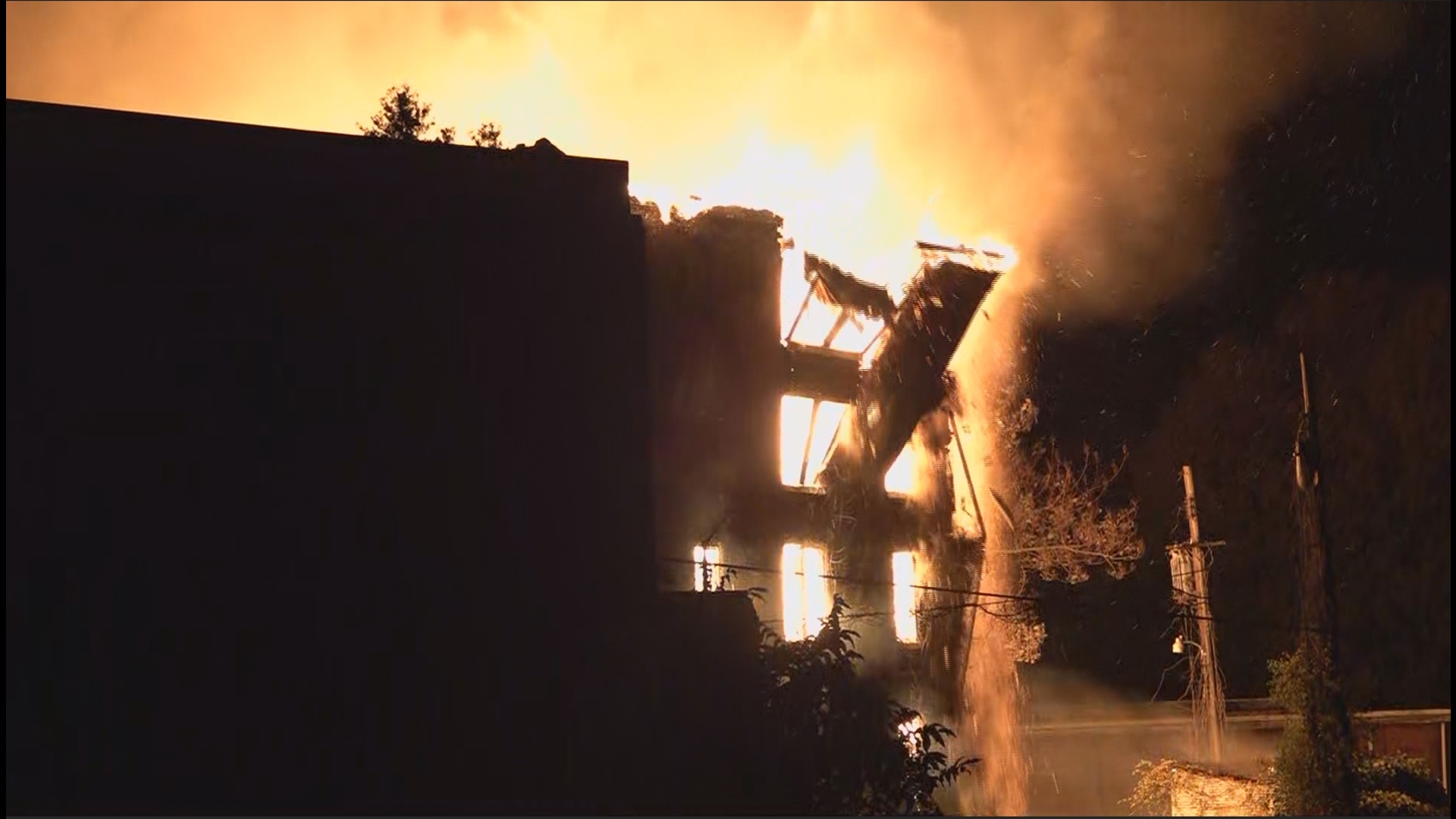 A portion of wall could be seen collapsing due to a large fire on the campus of Knoxville College