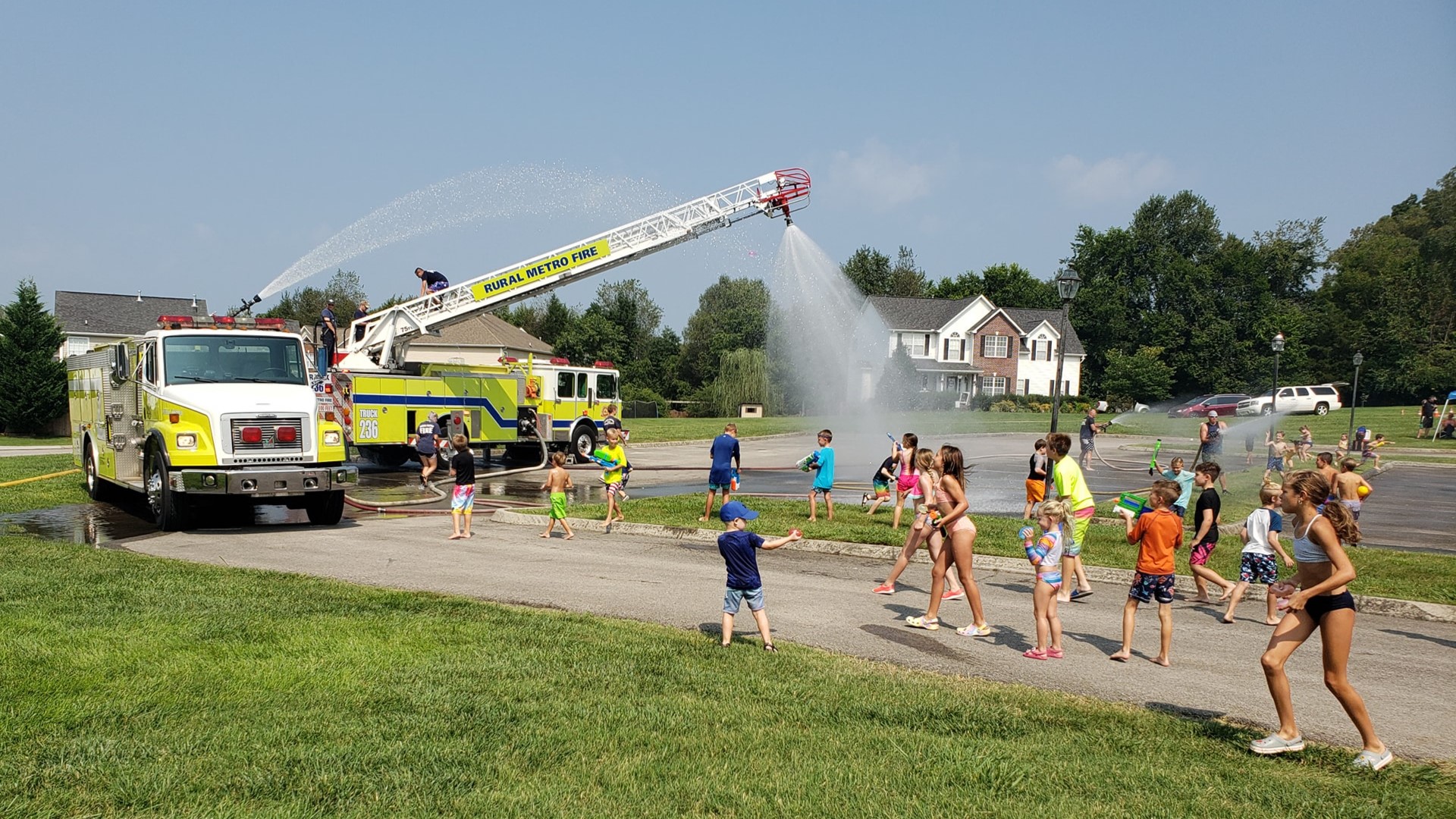 The water gun war begins! Rural Metro Fire crews face neighborhood children in large water gun