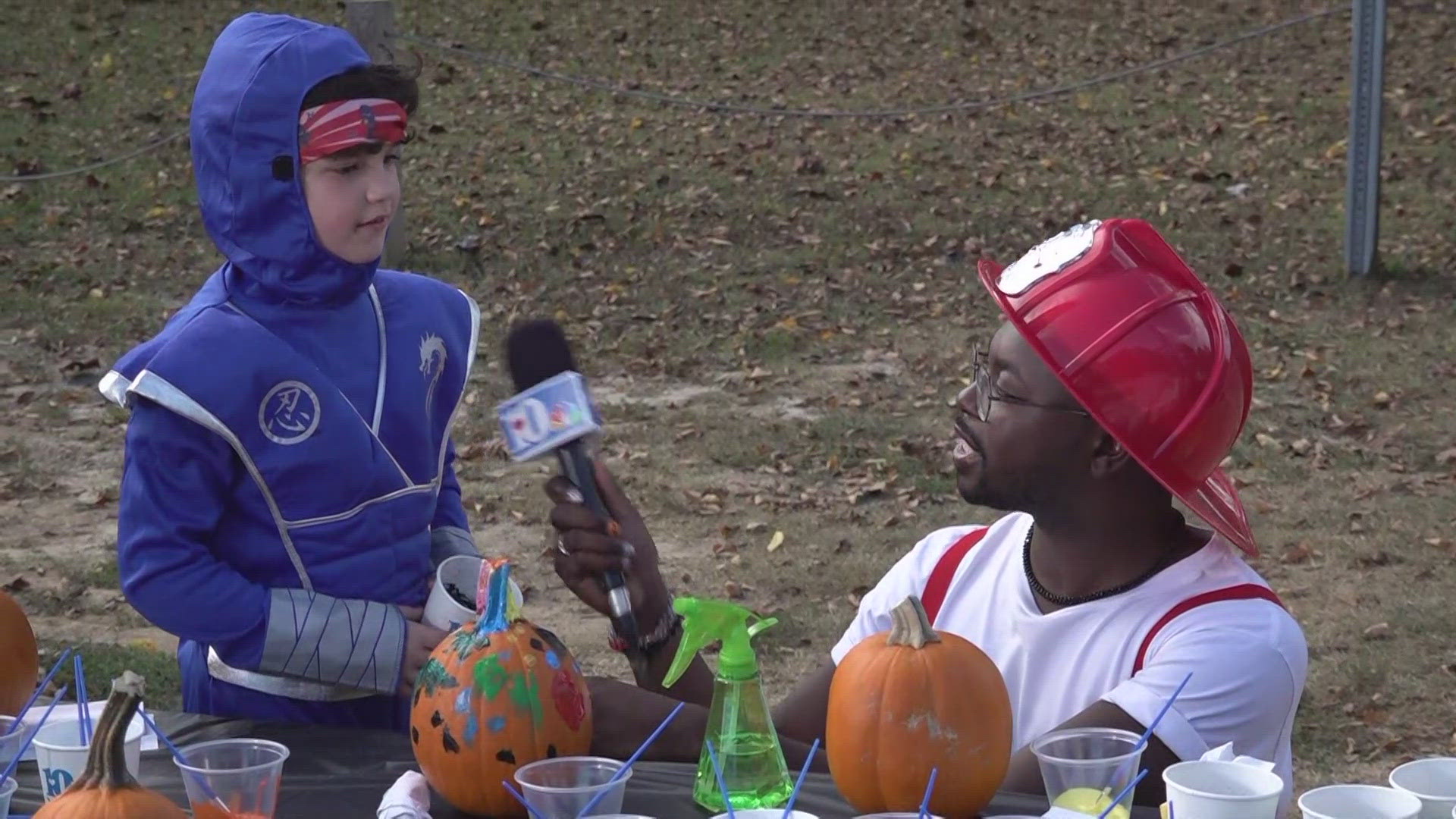 Guy helped Tevian paint a pumpkin for Halloween as part of 10Weather Education Day with KUB.