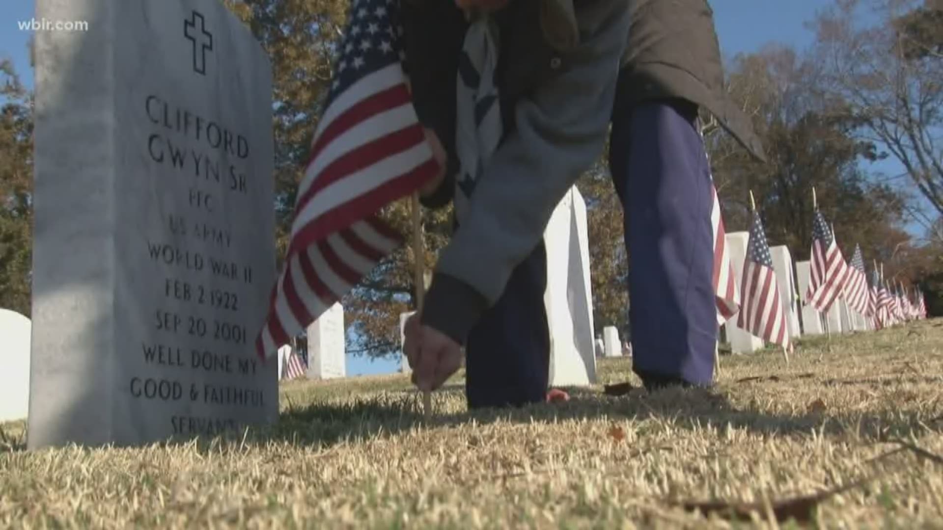 Volunteers paid their respects by placing American flags along each veteran's grave.