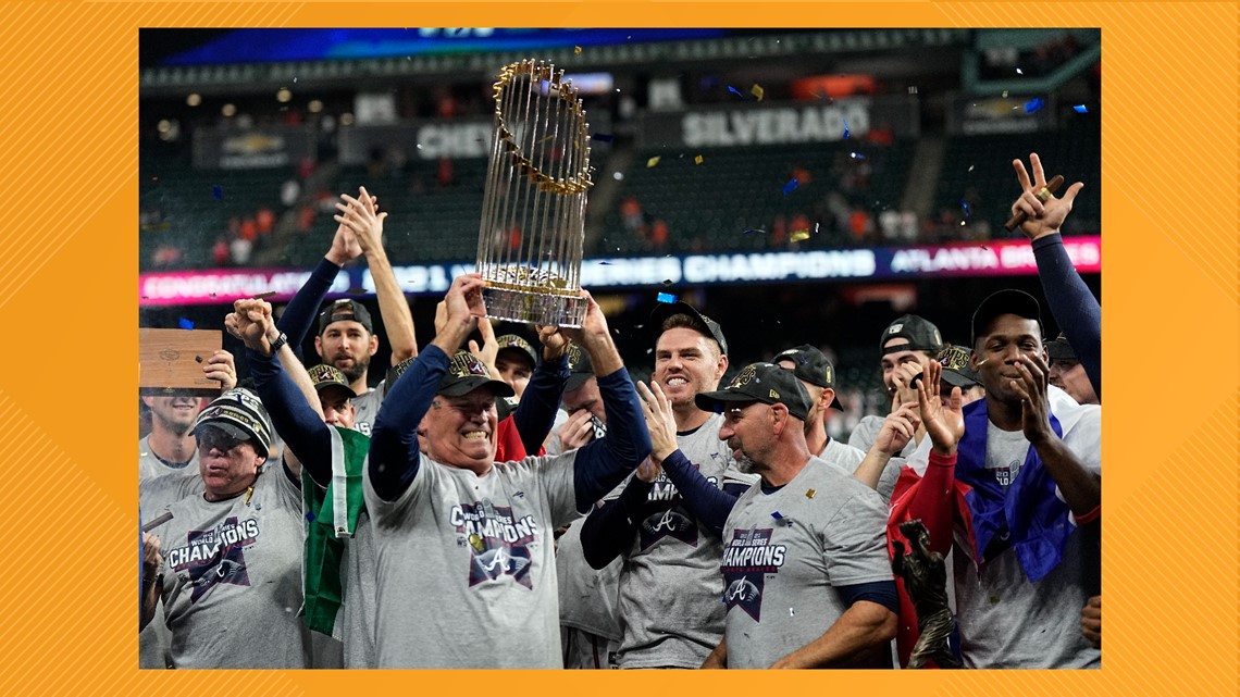 Take picture with Atlanta Braves World Series trophy at UT basketball game