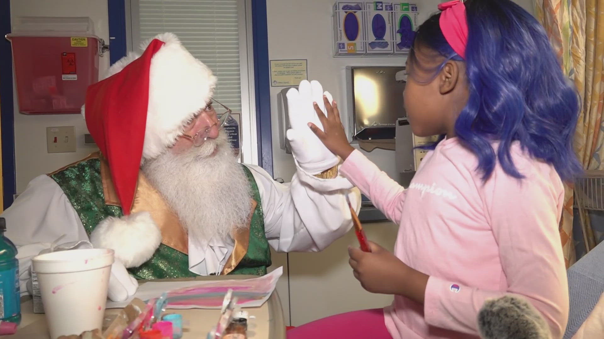 Santa delivered gifts to the children with some help from the staff members.