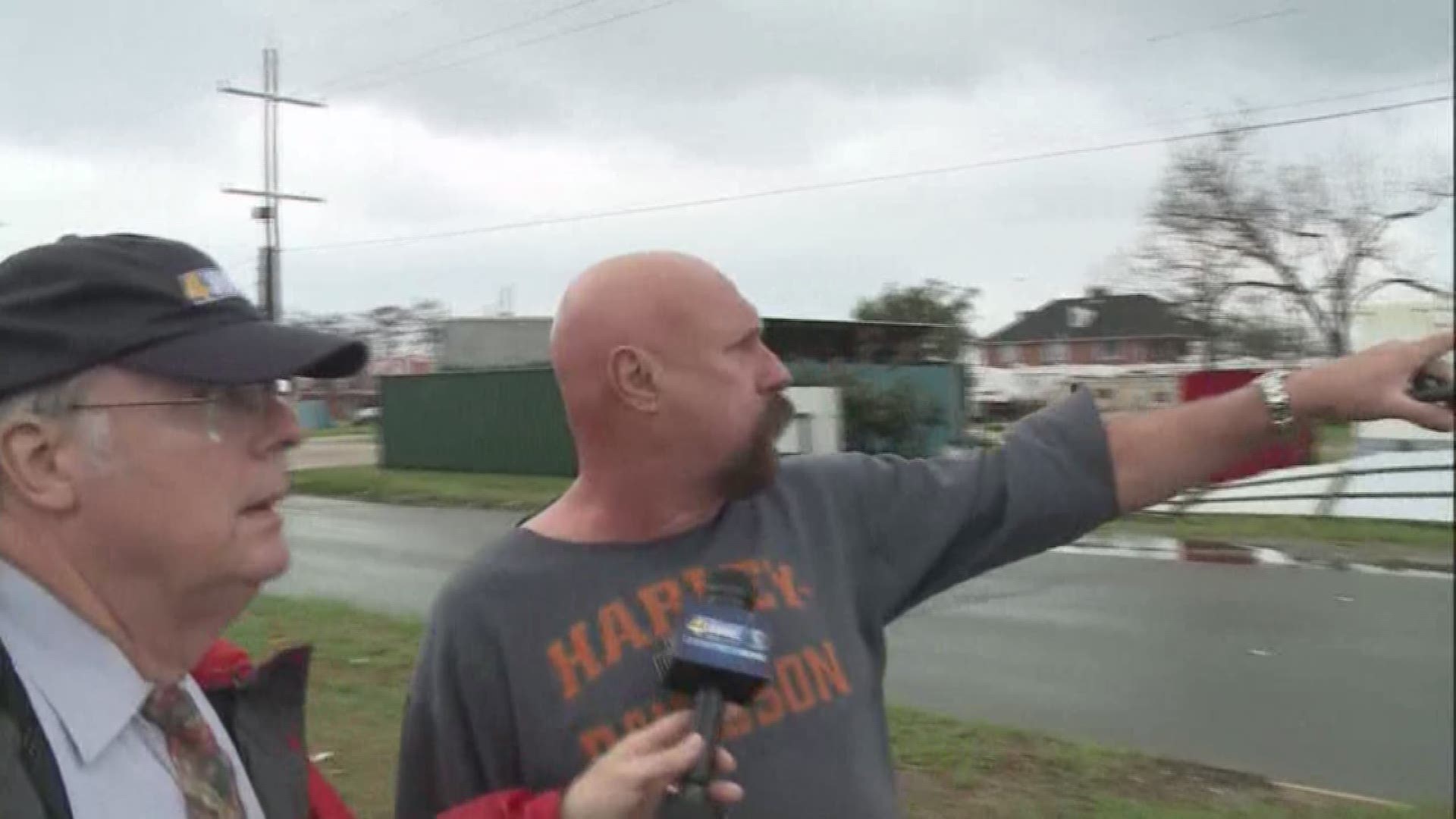 Bill Capo talks to a man saw a funnel cloud in N.O. East Tuesday.