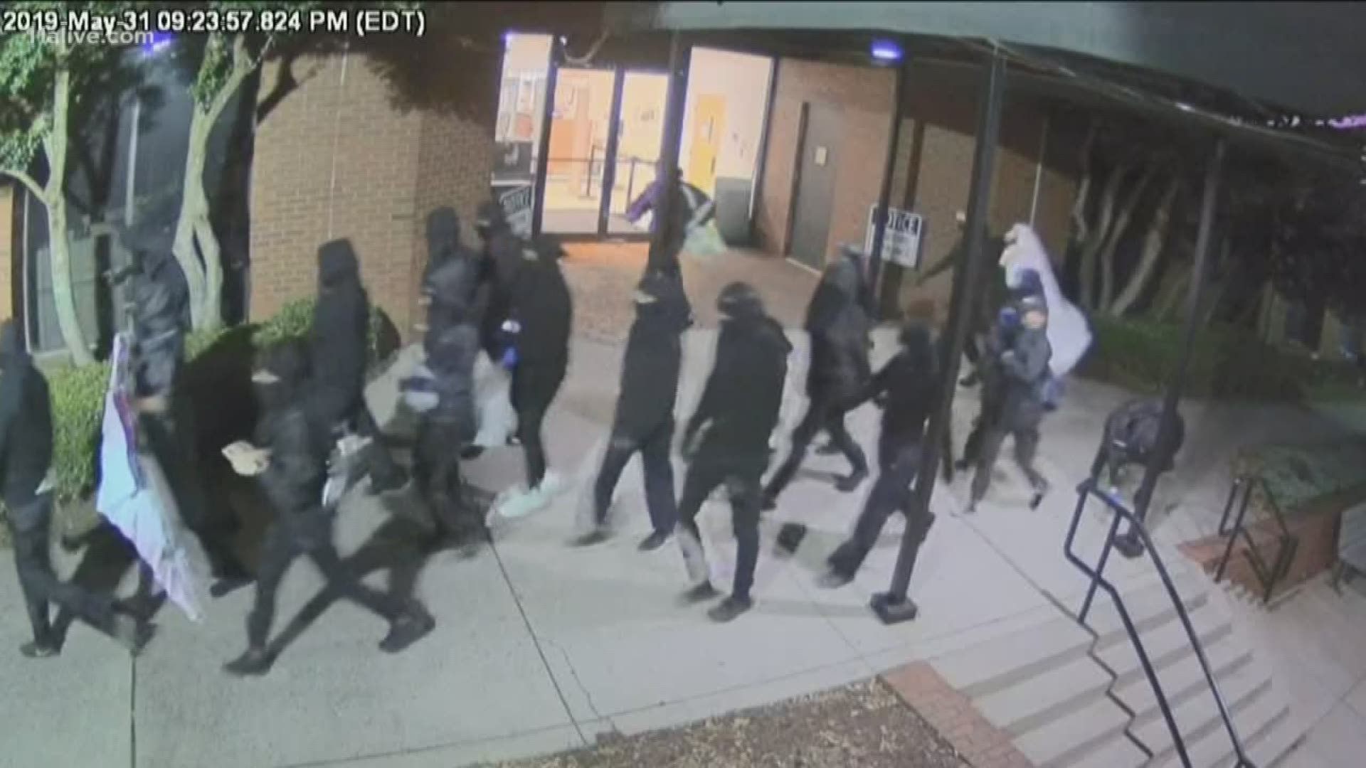 Video showed 20 to 26 people armed with hammers, pickaxes and spray paint swarm the building.
